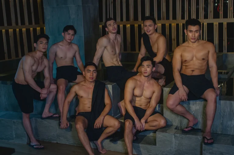 a group of Filipino men sitting around a Jacuzzi