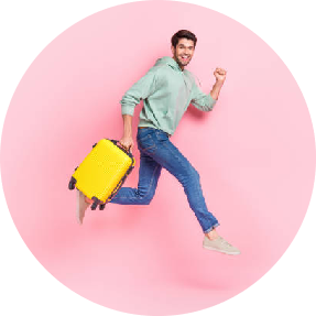 Man with suitcase jumping in the air with a yellow suitcase on a pink background
